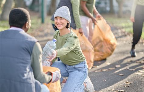 Volunteer Community Service And People Cleaning Plastic In Park With