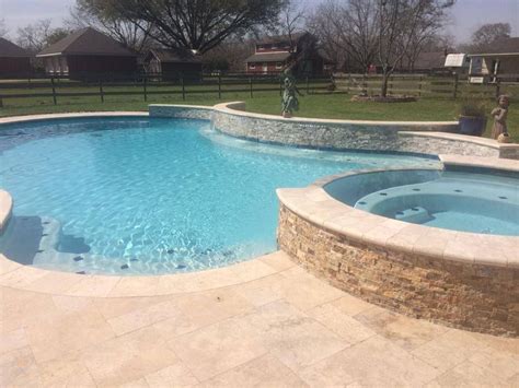Free Form Swimming Pool With Waterfall And Spa Travertine Deck And
