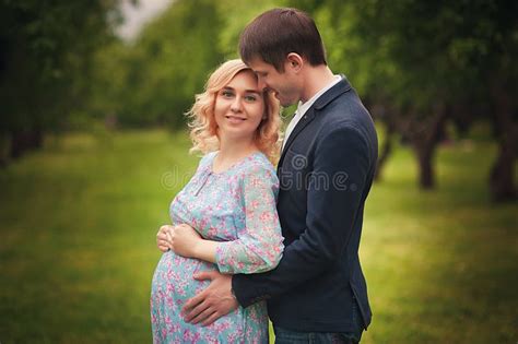 Image Of Beautiful Pregnant Woman And Her Handsome Husband Hugging The Tummy Stock Image Image