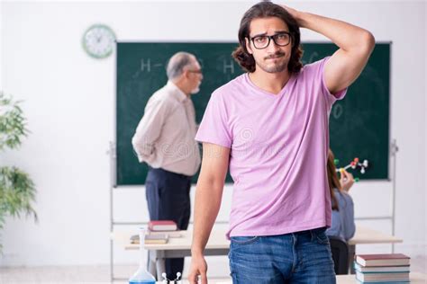 Old Chemist Teacher And Two Students In The Classroom Stock Image