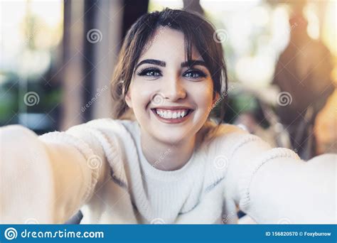 Smiling Girl Taking Selfie With Her Hands For Social Networks While