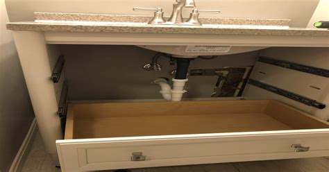 Trying to install this new vanity. Drawer is hitting pipe. What do I do