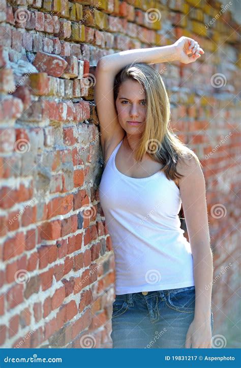 Young Woman Against A Brick Wall Stock Image Image Of Pretty Leaning