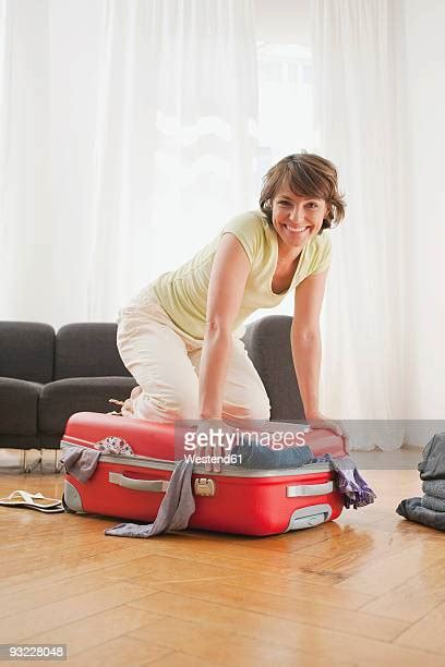 Mature Woman Packing Suitcase Photos And Premium High Res Pictures Getty Images