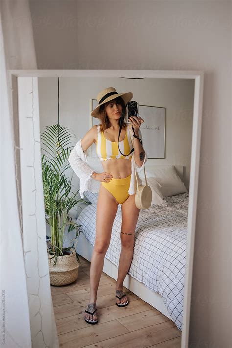 Woman Doing A Selfie In The Mirror In A Bikini del colaborador de Stocksy Susana Ramírez