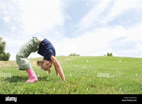 Bending Over Backwards Girl On Grass Stock Photo Alamy