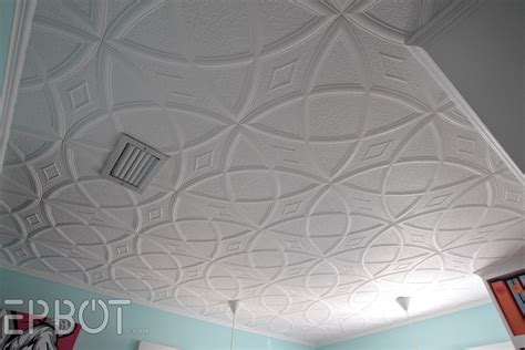 Installing tiles can cover up an unsightly ceiling and add freshness to the room. EPBOT: DIY Faux Tin Tile Ceiling