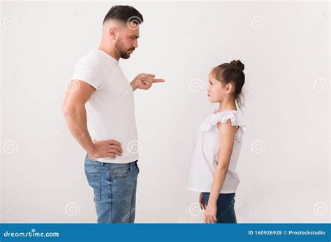 angry father pointing his daughter and giving lesson to her royalty free stock image