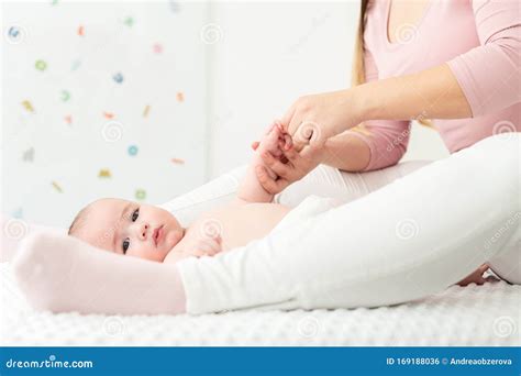 Baby Massage Background Mother Gently Massaging Her Baby Boy Baby Lying On Back And Looking At