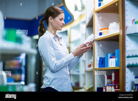 Pharmacist Checking A Bottle Of Drug Stock Photo Alamy