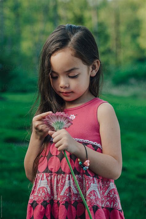 Little Girl Holding Flower By Ronnie Comeau