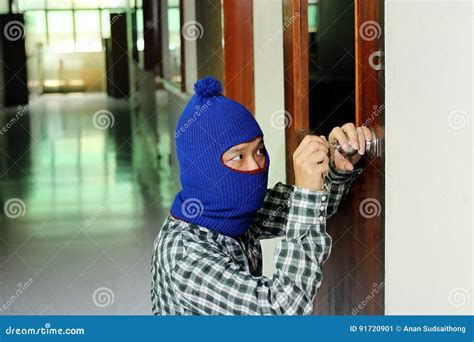 masked burglar using lock picker to open locked door royalty free stock image cartoondealer