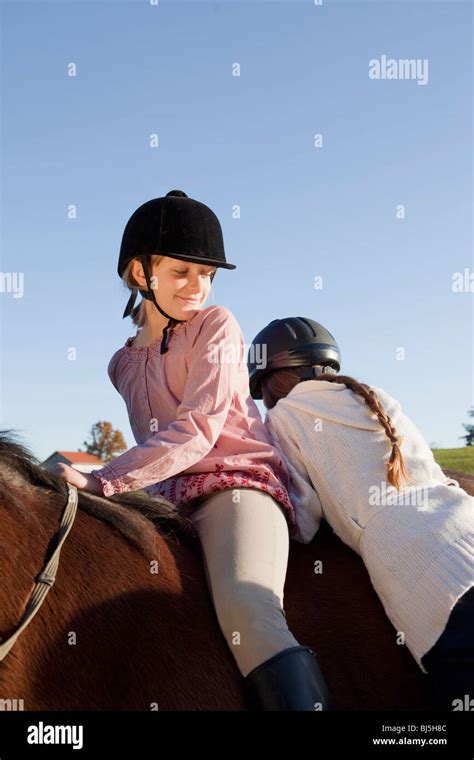 Girl Mounting A Horse Stock Photo Alamy