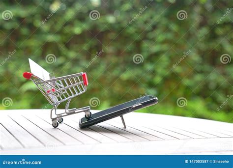 Online Shopping Concept Trolley Cart And A Smart Phone Stock Image