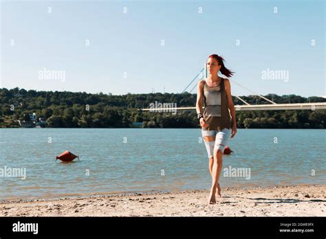 Full Length Of Redhead Woman Walking On The Sand At The Beach Copy Space Stock Photo Alamy