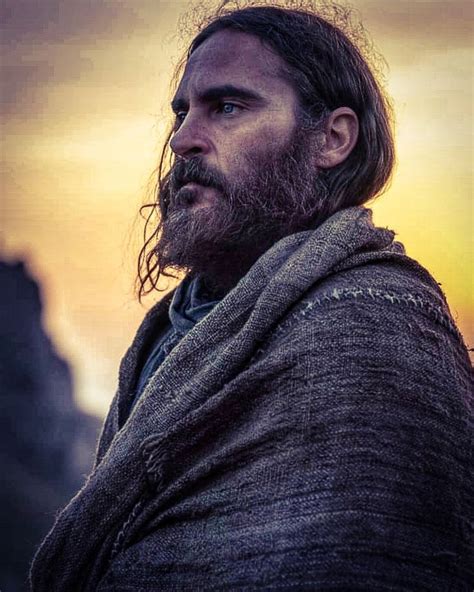A Man With Long Hair And Beard Wearing A Shawl