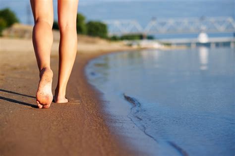 Premium Photo Woman Legs And Feet Walking On The Sand Of The Beach