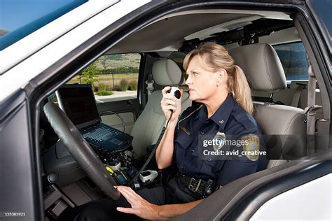 Female Police Officer Talking On Radio In Vehicle High Res Stock Photo