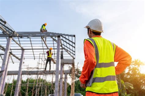 3 Workers In Construction Site Engineer Technician Watching Team Of