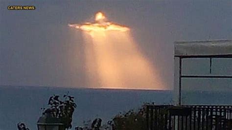 Image Of Jesus Shining Through The Clouds During Sunset