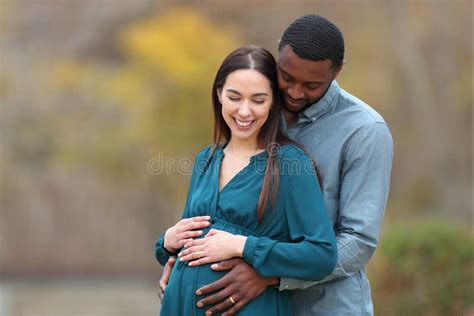Happy Interracial Couple Looking At Pregnant Belly Stock Photo Image
