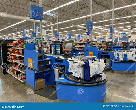 The Cashier Stands Checkout Counters At A Walmart Store With No People