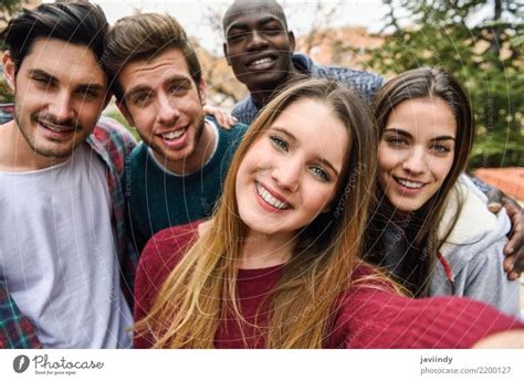 Multiracial Group Of Friends Taking Selfie In A Urban Park A Royalty