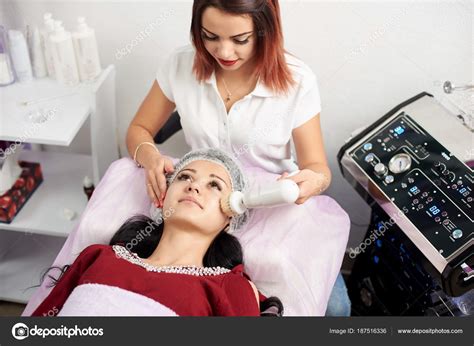 Female Cosmetologist Is Giving Facial Cleaning With A Rotating Brush To
