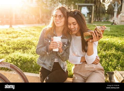 Image Of Two Young Happy Women Friends Outdoors With Bicycles In Park