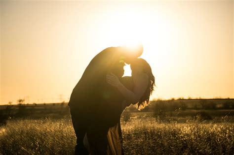 Man And Woman Kissing On Grass Field During Day Time Photo Free Flare Image On Unsplash Real