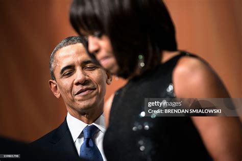 Us President Barack Obama Listens While Us First Lady Michelle Obama