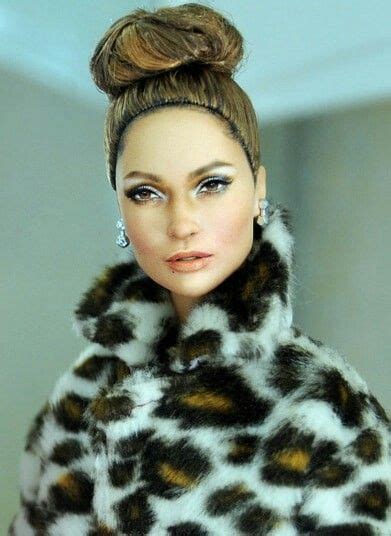 A Barbie Doll Wearing A Leopard Print Fur Coat And Matching Earrings
