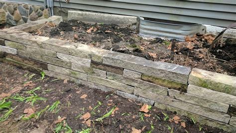 A retaining wall is a diy front yard landscaping idea that can be done with boulders or large river rock, depending on the size of the wall. DIY Retaining Wall Makeover - Miss Smarty Plants