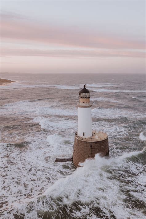 Waves Hitting A Lighthouse In Scotland Premium Photo Rawpixel
