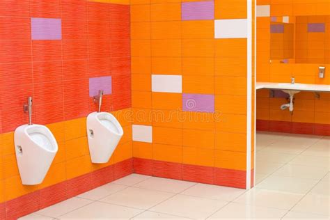 Bright Creative Public Toilet Design In Yellow Orange Stock Photo