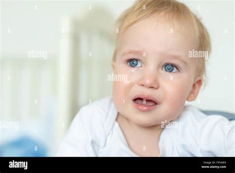 Cute Caucasian Blond Toddler Boy Portrait Crying At Home During