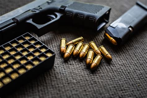 Bullets And Gun On Black Velvet Desk Stock Photo Download Image Now
