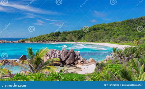Beautiful Rocky Beach With Palm And The Turquoise Sea On Paradise