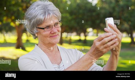 Hip Grandma Taking Selfies At The Park Stock Photo Alamy