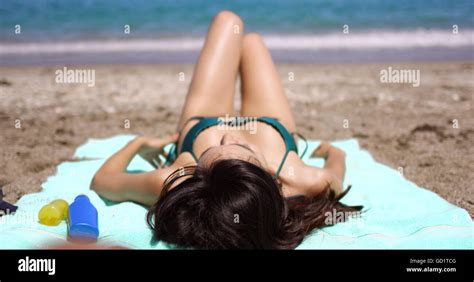 Woman Suntanning On A Tropical Beach In Summer Sun Stock Photo Alamy