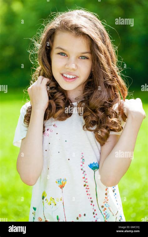 Portrait Of A Beautiful Young Little Girl On The Background Of Summer
