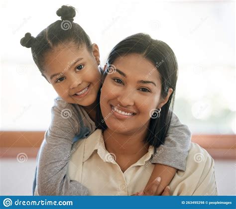 Portrait Of Two Mixed Race Young Females Only Smiling And Looking Relaxed At Home Black African
