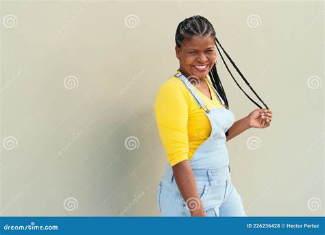 Mature Black Woman Posing Against The Wall Background Stock Photo