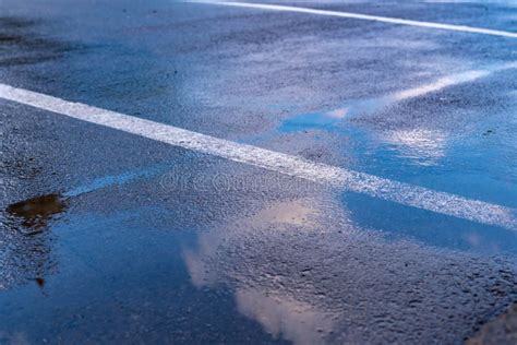 Close Up Wet Roadway Traffic Territory With Puddles After Rain Stock