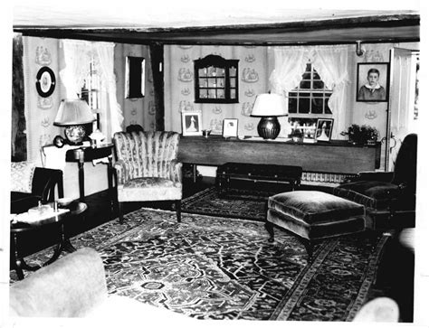 An Old Black And White Photo Of A Living Room With Couches Chairs