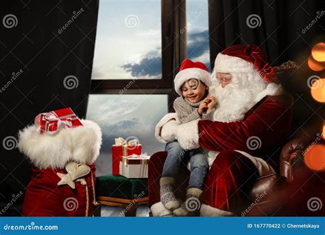 Santa Claus With Little Boy Near Window Christmas Time Stock Photo