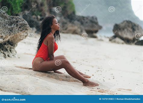 Beautiful Dark Skinned Girl In Swimwear Posing On White Sand Beach