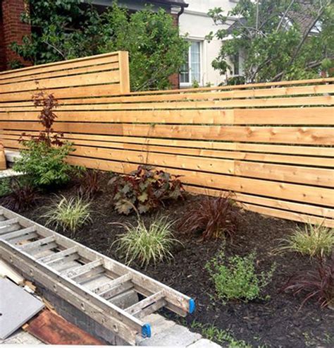 The Staggered Widths In This Modern Horizontal Fence Break Up The