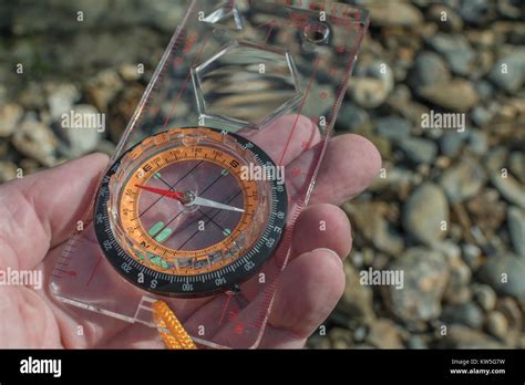 Orienteering Compass In Hand Pointing East For Business Direction Navigation Moral Compass
