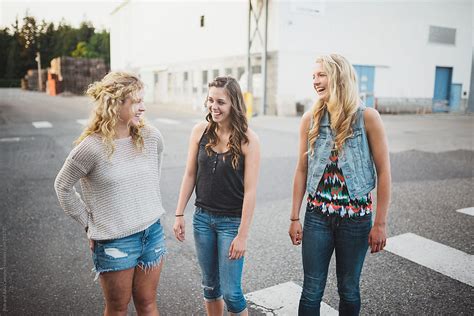 group of real teenage girls laughing together outside by rob and julia campbell stocksy united